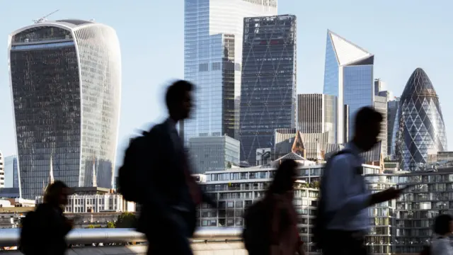 Silhouetted commuters in the City of London