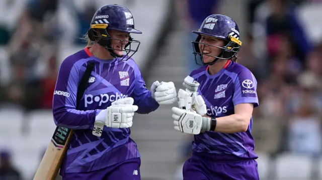 Hollie Armitage (left) and Georgia Wareham touch gloves
