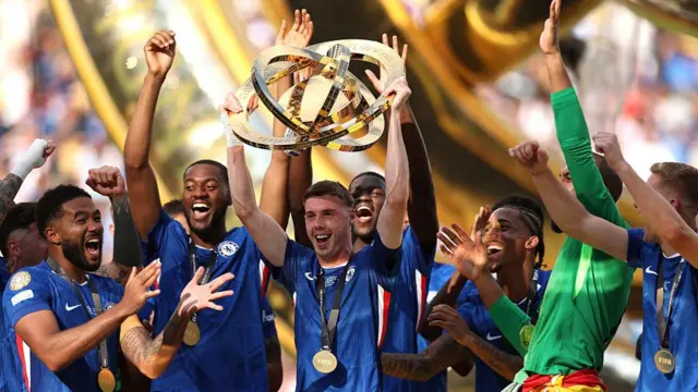 Cole Palmer of Chelsea FC lifts the FIFA Club World Cup trophy