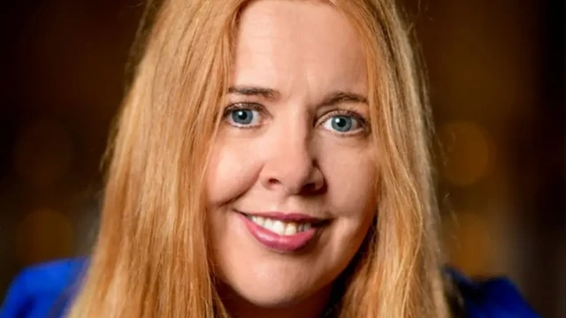 Celia Gaze smiling into the camera. She has long light brown hair.
