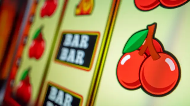 Images on a gambling machine showing bars and cherries