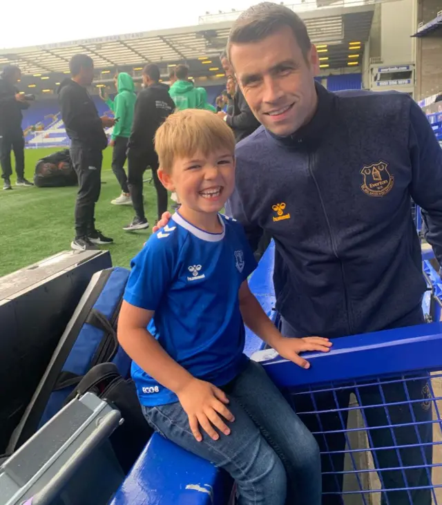 A picture of a small boy in an Everton shirt with Seamus Coleman