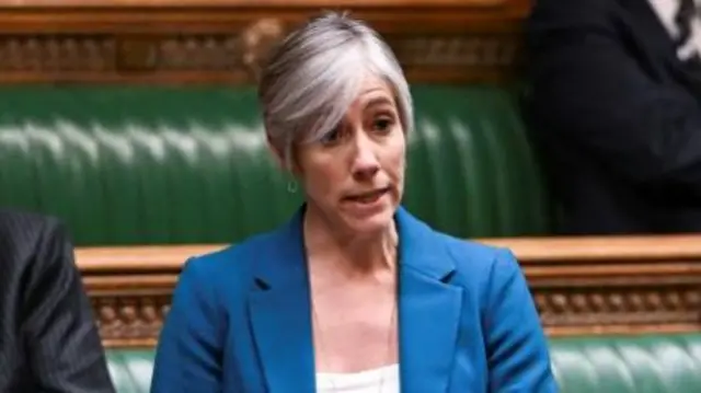 Daisy Cooper Mp in a blue suit in parliament