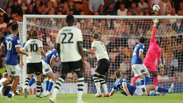 Cardiff goalkeeper Nathan Trott jumps and stretches his hands as the ball goes over the bar