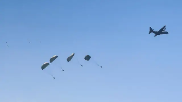 Aid packages are airdropped over Gaza, as seen from Gaza City