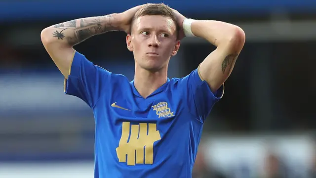 Jay Stansfield with his hands on his head