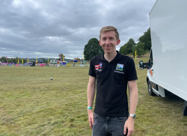 Matt Joyce, of MJ Balloons, standing on Ashton Court Estate next to a large white van.
