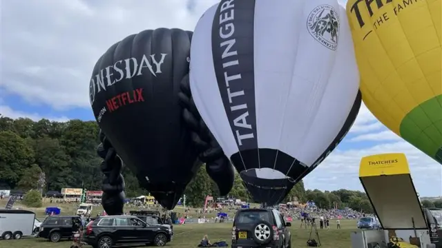 Several balloons lined up on Ashton Court Estate ready for take off