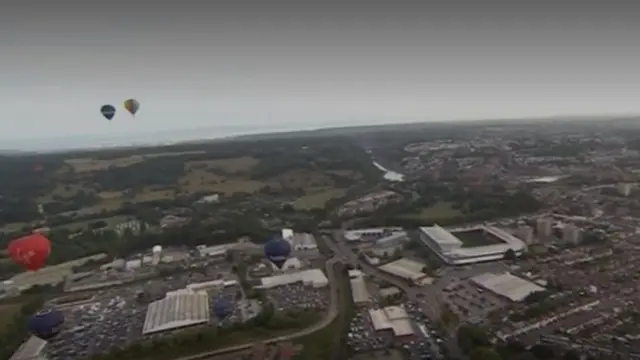 Balloons flying over Bristol with Aston Gate in view