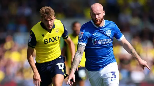 Connor Ogilvie and Stanley Mills battle for the ball