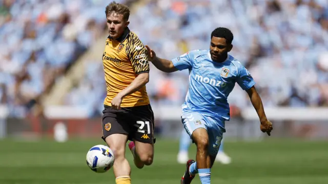 Joe Gelhardt of Hull City and Jay Dasilva of Coventry City battle for possession