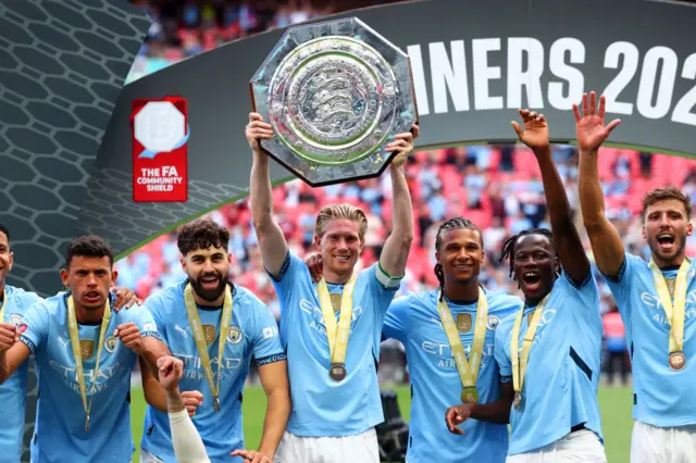 Kevin de Bruyne lifting the Community Shield above his head