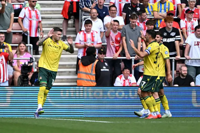Josh Windass of Wrexham celebrates scoring his team's first goal from the penalty spot