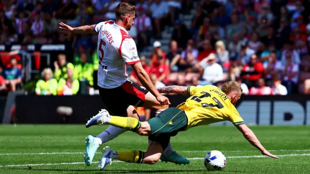 Southampton's Jack Stephens and Wrexham's Lewis O'Brien (right) battle for the ball