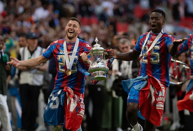 Crystal Palace running with the FA Cup trophy