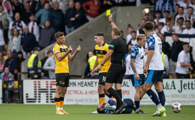 Livingston's Graham Carey is shown a yellow card for a foul on Falkirk's Brad Spencer