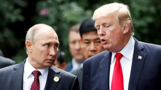 FILE PHOTO: U.S. President Donald Trump and Russia's President Vladimir Putin talk during the family photo session at the APEC Summit in Danang, Vietnam November 11, 2017