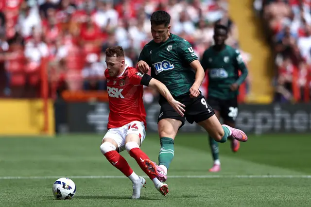 Sonny Carey of Charlton Athletic is challenged by Luca Kjerrumgaard of Watford