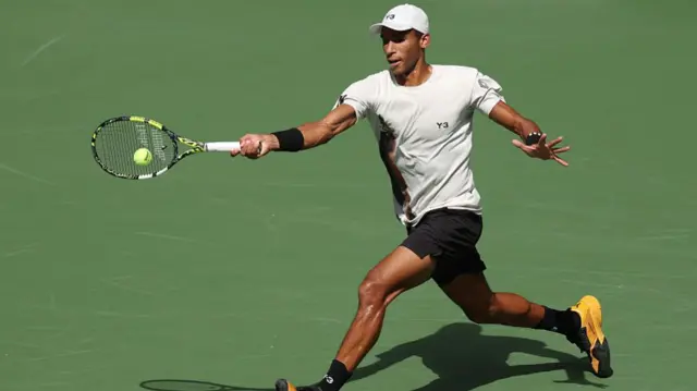 Felix Auger-Aliassime returns with a forehand