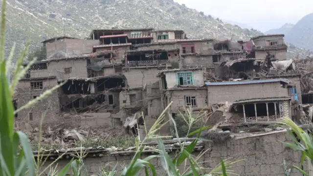 Damaged buildings on a mountainside