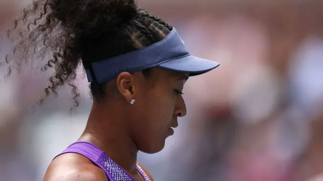 Naomi Osaka looks on at the US Open