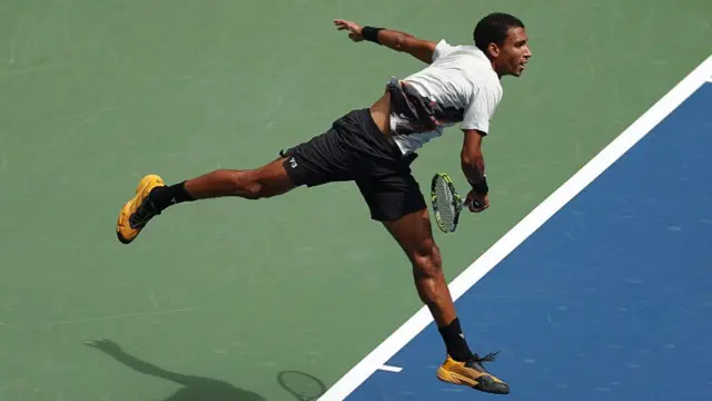 Felix Auger-Aliassime serves vs Andrey Rublev.