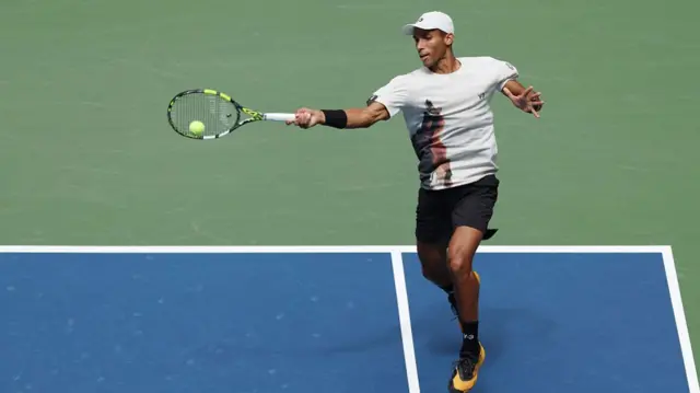 Felix Auger-Aliassime returns with a forehand vs Andrey Rublev