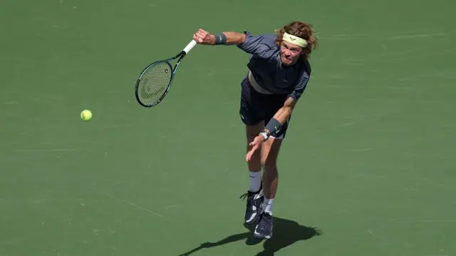 Andrey Rublev serves to Felix Auger-Aliassime
