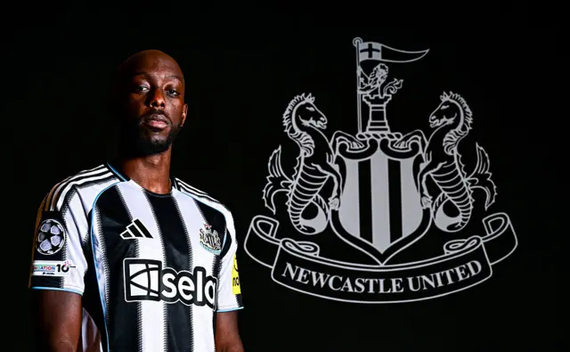 Yoane Wissa stands in his Newcastle shirt