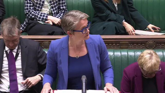 Cooper looks up towards the Speaker as she speaks at the dispatch box in the House of Commons