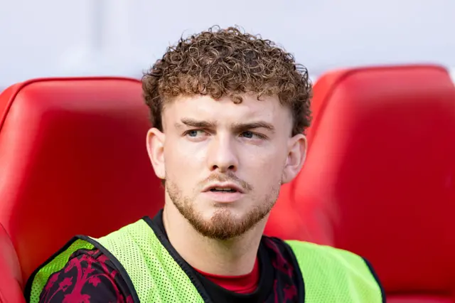 Harvey Elliott sits on the Liverpool bench
