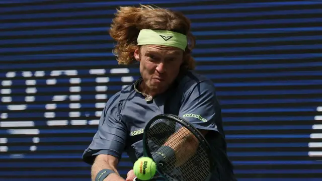 Andrey Rublev returns to Felix Auger-Aliassime with a backhand