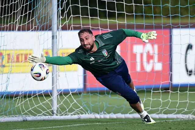 Gianluigi Donnarumma dives for a ball in Italy training