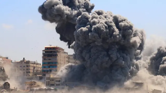 An enormous plume of dark smoke rises from the strike. Other tall buildings can be seen nearby, but the ground is obscured by dust and smoke