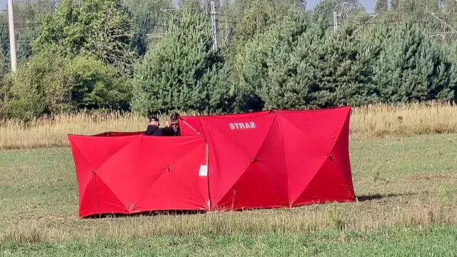 Red barriers covering the area a drone is thought to have landed in a field