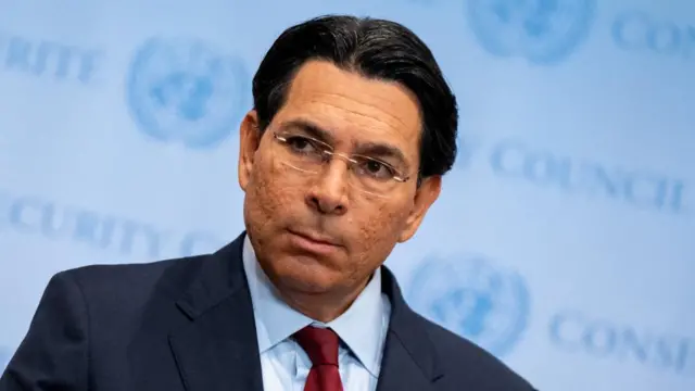 Danny Danon is photographed in front of a UN Security Council banner