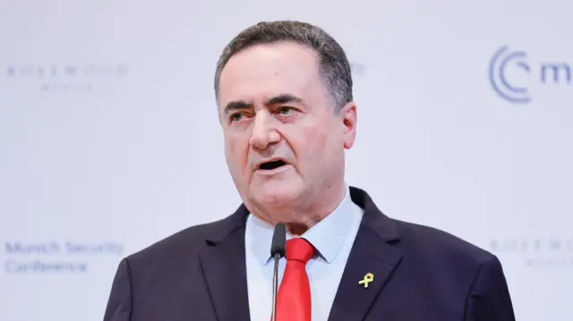 A man in a blue suit and red tie