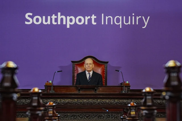 The Southport Inquiry chairman Sir Adrian Fulford, sitting at the front of the court