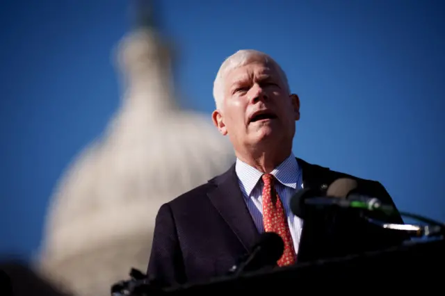 Pete Sessions speaking into a microphone in front of the US capitol