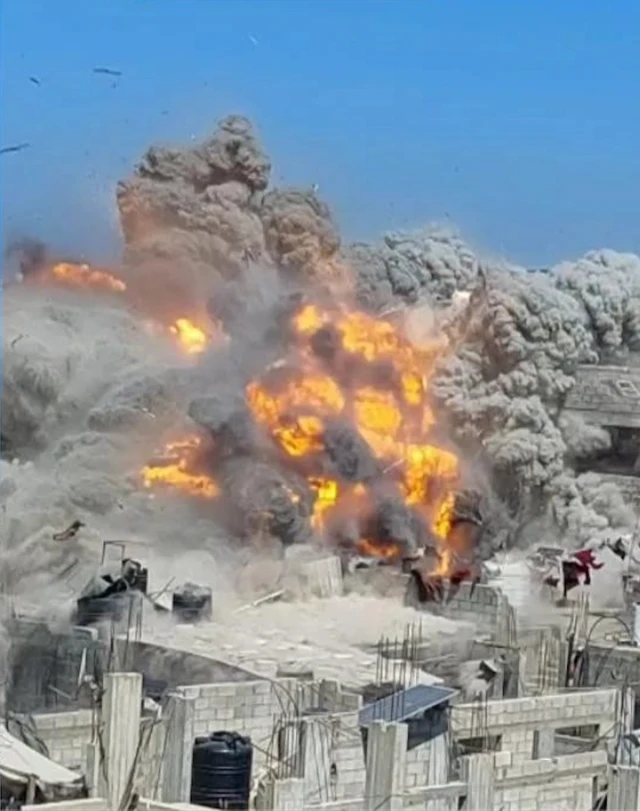 An explosion destroys a multi-storey residential building in Gaza City
