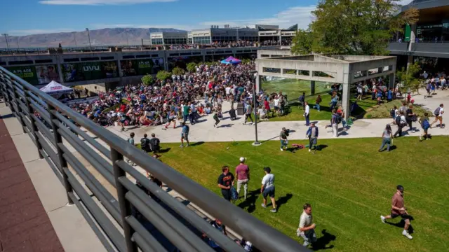 A few people begin to run from the crowd at the Charlie Kirk speaking event.
