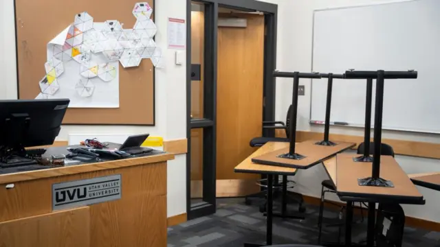 A barricade of tables inside a classroom.