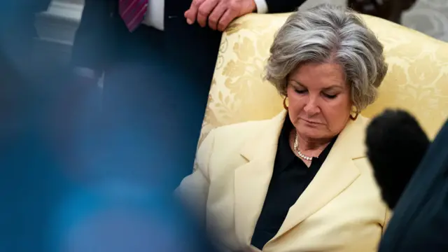 Susie Wiles, White House chief of staff, looking down while seated in the Oval Office