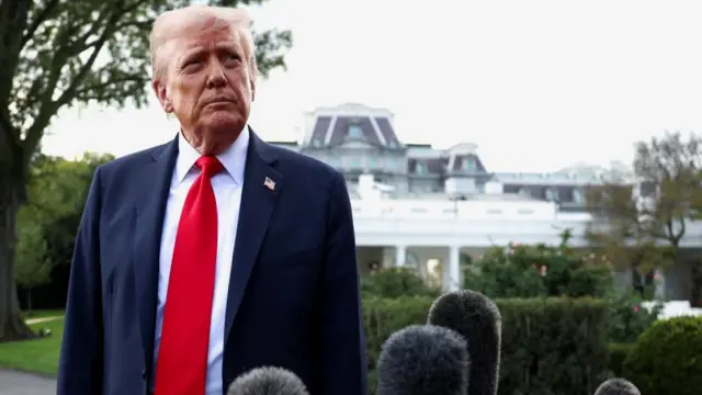 U.S. President Donald Trump listens to a question from the media before boarding Marine One upon departure for New York