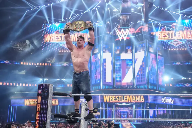 John Cena lifting the WWE Championship at Wrestlemania 41