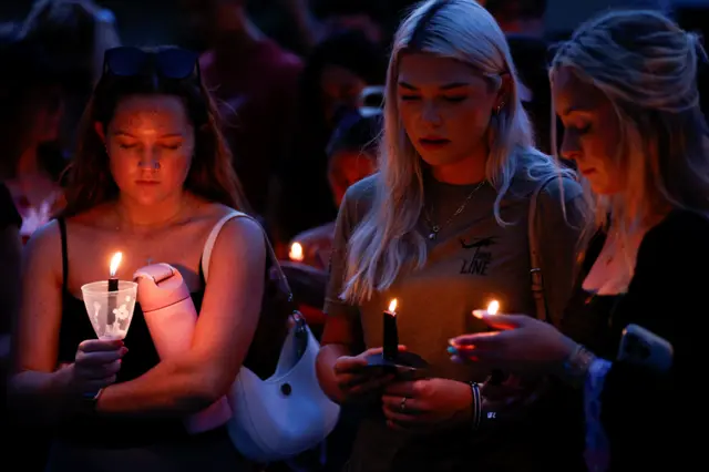 People attend a vigil and memorial on the campus of Florida Atlantic University in Boca Raton