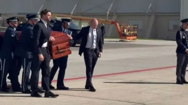 JD Vance leads men dressed in military uniform in carrying Kirk's casket at airport