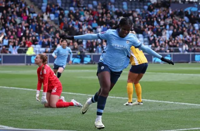 Bunny Shaw celebrates her goal against Brighton last season