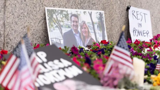 A photo of  Melissa Hortman and her husband Marc amongst flowers and tribues