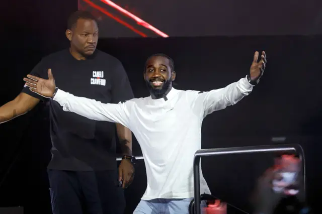 Terence Crawford smiling with his arms out wide